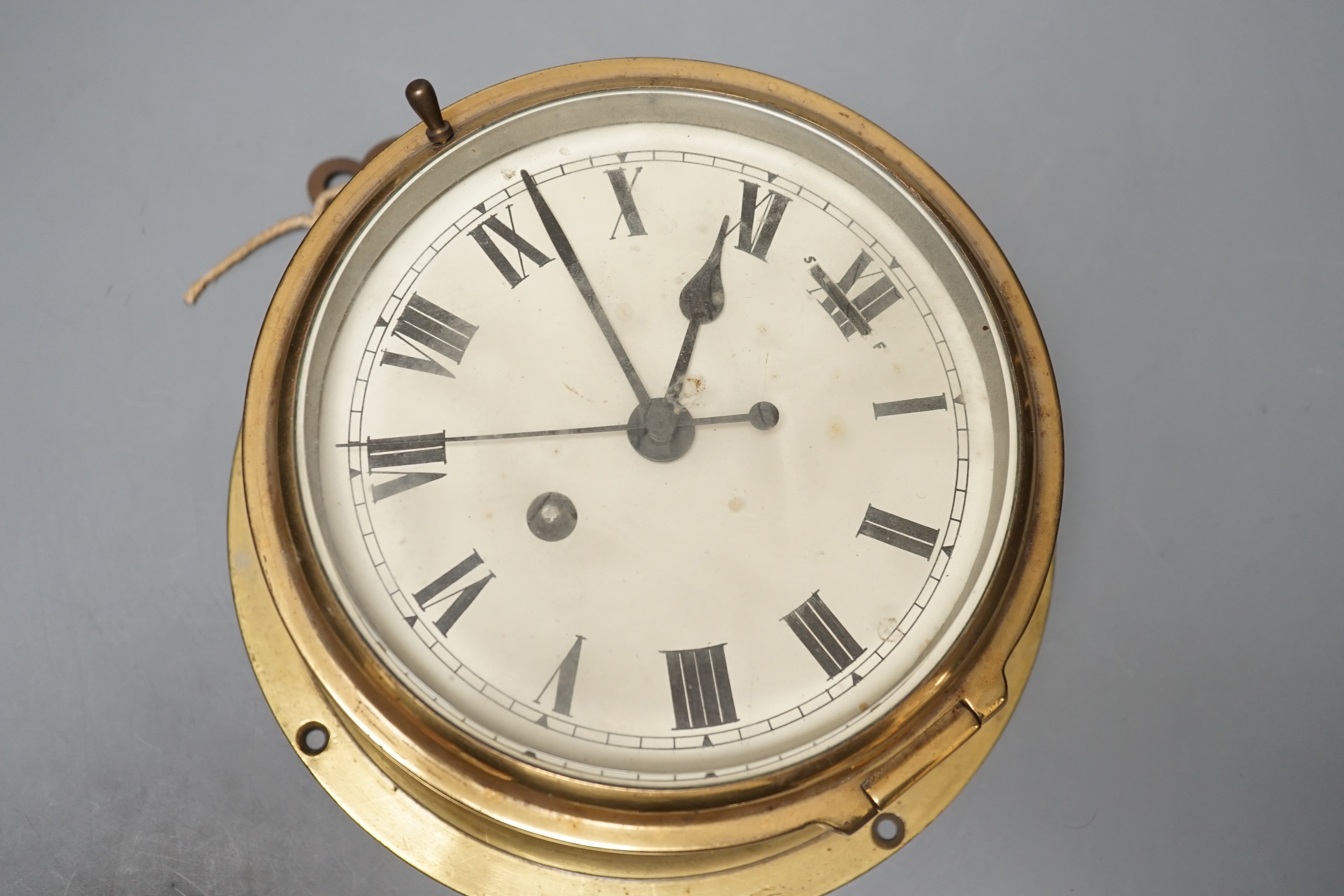 An early 20th century brass ships bulkhead timepiece with key